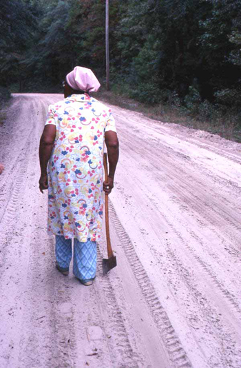 Lucreaty Clark carrying her ax in search of white oak to make baskets (not after 1979)