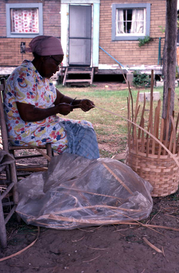 Lucreaty Clark preparing a strip of white oak for her basket (not after 1979)