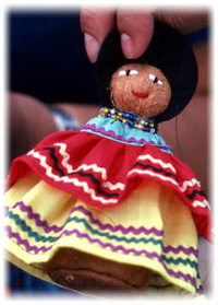 Seminole doll made by Mary Billie being held up for the camera: Big Cypress Seminole Indian Reservation, Florida (not after 1980)