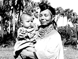 Seminole woman Leona Smith holding a child