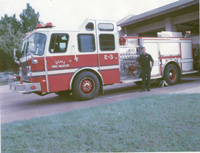 Firemen Aboard the First Hose Wagon in 1905 Now