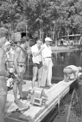 Director Jack Arnold speaking to underwater cameraman Scotty Welbourne on the set of "Revenge of the Creature" movie.