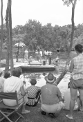 Spectators watching crew work on floating platform during filming of the "Revenge of the Creature" movie at Silver Springs.