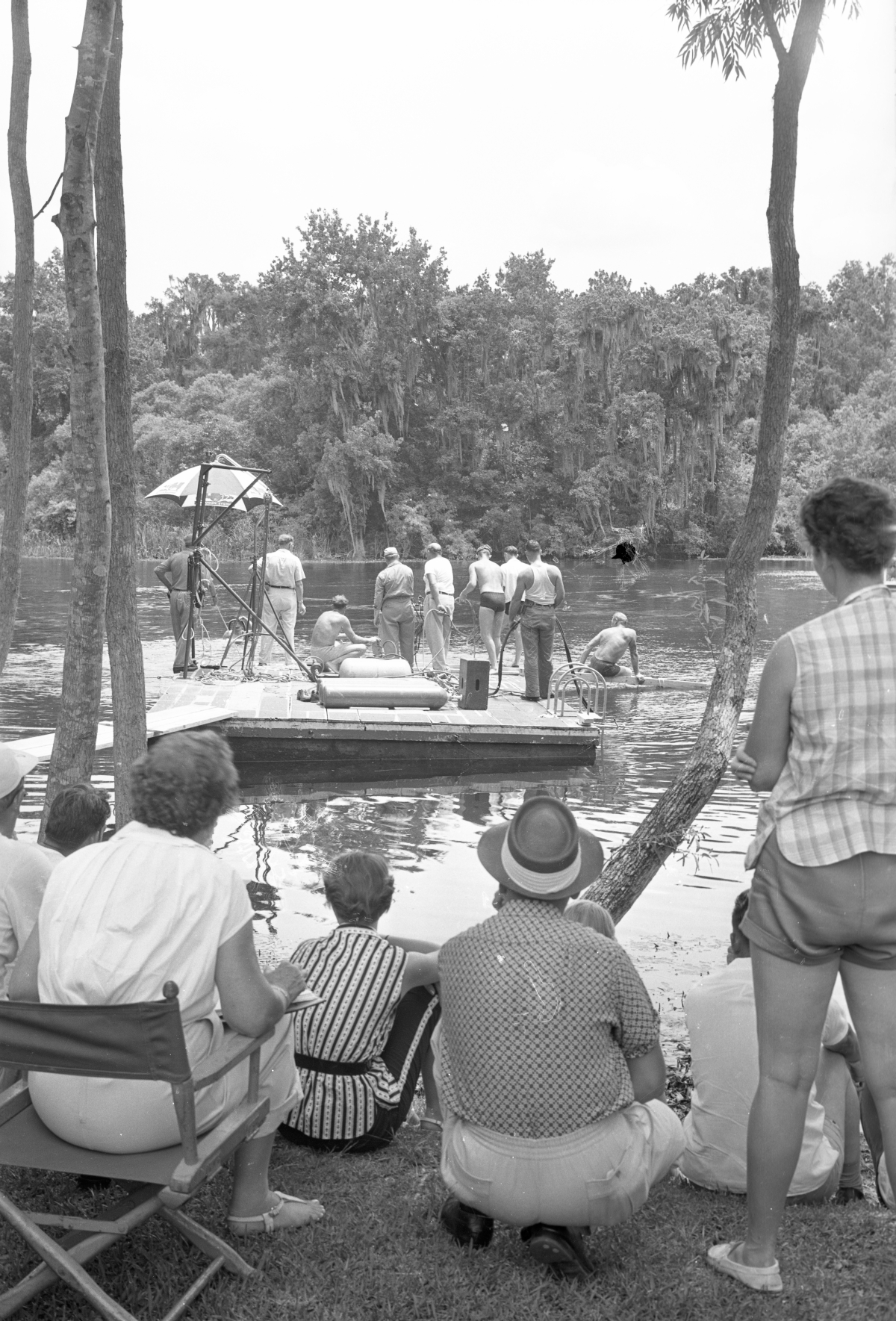 Spectators watching crew members work on a floating platform during filming of Revenge of the Creature at Silver Springs, 1954. Photo by Bruce Mozert.