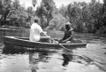 Crew member in rowboat with creature character on film location for "Revenge of the Creature" movie at Silver Springs.