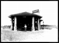 Bill Trammell standing in front of Holt's Standard Oil station - Newberry, Florida