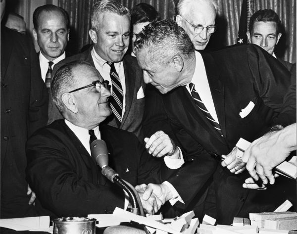 LeRoy Collins with President Lyndon B. Johnson during the ceremonial signing of the Civil Rights Act on July 2, 1964