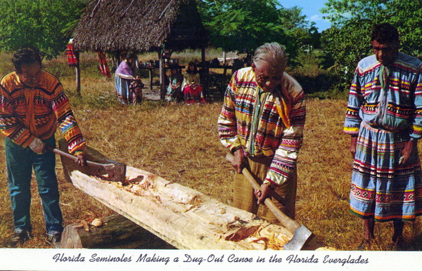 Florida Seminoles making a dug-out canoe in the Florida Everglades