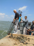 Governor Charlie Crist preparing to tong for oysters in Apalachicola Bay.