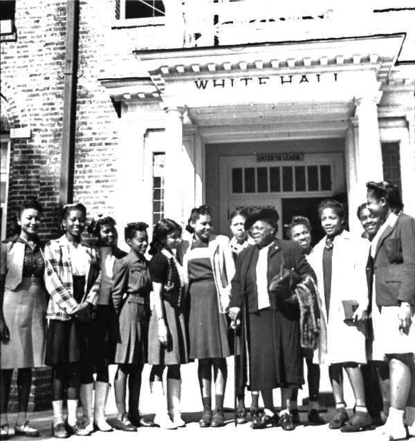 Mary McLeod Bethune with students in front of White Hall at Bethune-Cookman College.