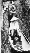 Marjory Stoneman Douglas canoeing with a Miccosukee Indian at the Miccosukee Cultural Center in the Everglades