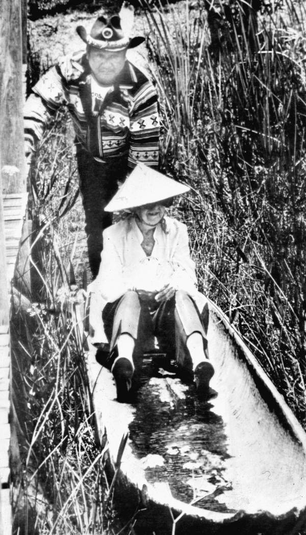 Marjory Stoneman Douglas canoeing with a Miccosukee Indian at the Miccosukee Cultural Center in the Everglades