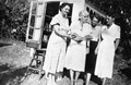 Marjory Stoneman Douglas beside the Coco Plum Woman's Club public library book wagon in South Miami.