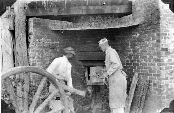 Loading a firebox at a turpentine distillery