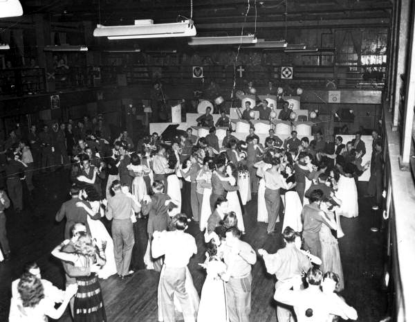 Soldiers and visitors dance to music from a live band at one of Camp Gordon Johnston's dance halls (circa 1944).