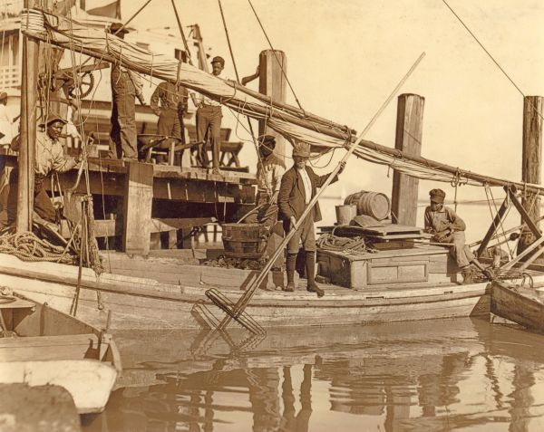 Oyster fishermen on a boat in dock at Apalachicola, Florida.