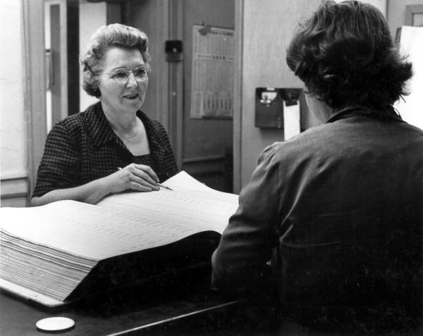 An employee at the Leon County Tax Assessor's office helps a customer (1961).