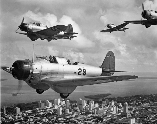 View showing U.S. Navy dive bombers flying over Miami during WWII.