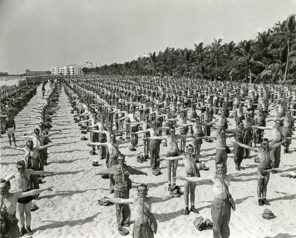 Soldiers performing training exercises on the beach during WWII - Miami Beach, Florida.