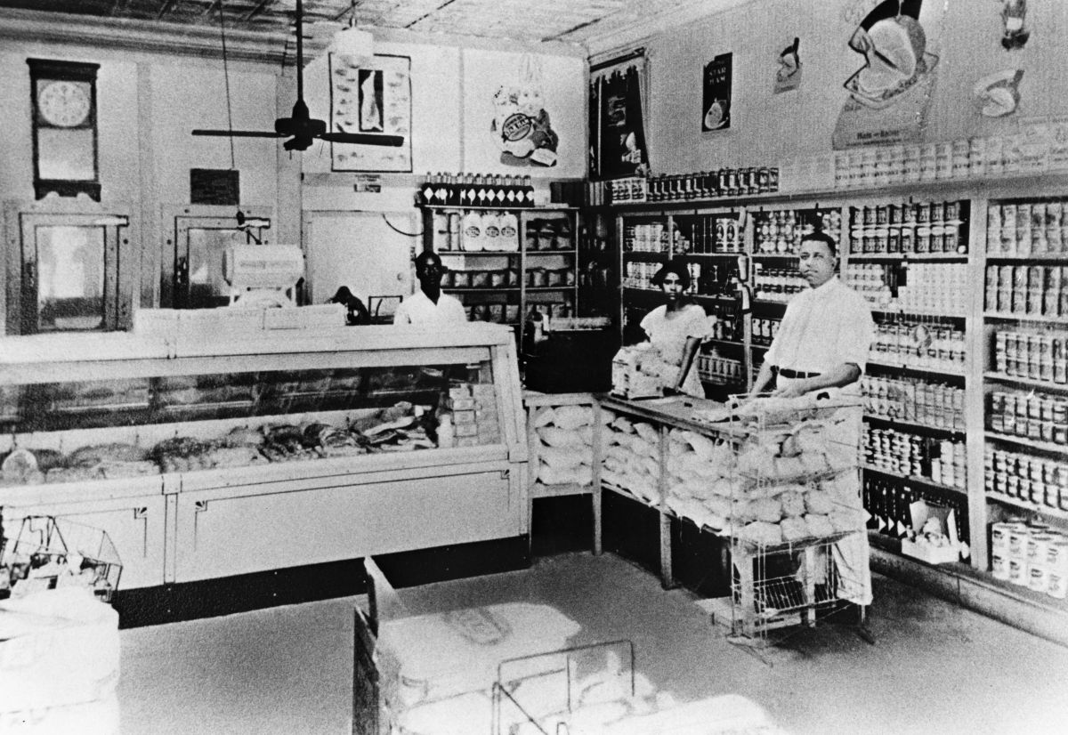 An interior view of the Palace Market in the predominantly African-American Lincolnville district of St. Augustine.  Owner Frank B. Butler stands at right (circa 1930s).