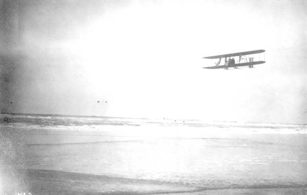 Burgess-Wright biplane flying over Daytona Beach. The pilot, Phillips Ward Page of Massachusetts, was hired to fly guests of the Clarendon Hotel over the beach as a novelty (1912).