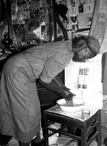 Midwife washing her hands prior to examining patient