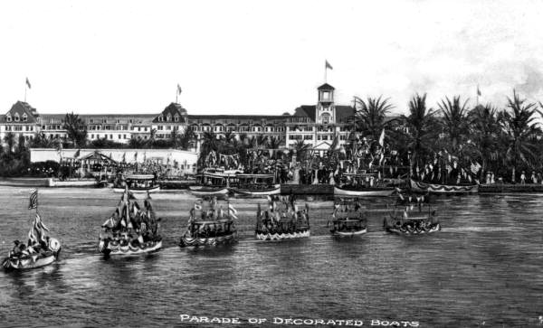 A floating parade of decorated boats in front of the Royal Poinciana Hotel at Palm Beach (circa 1900).