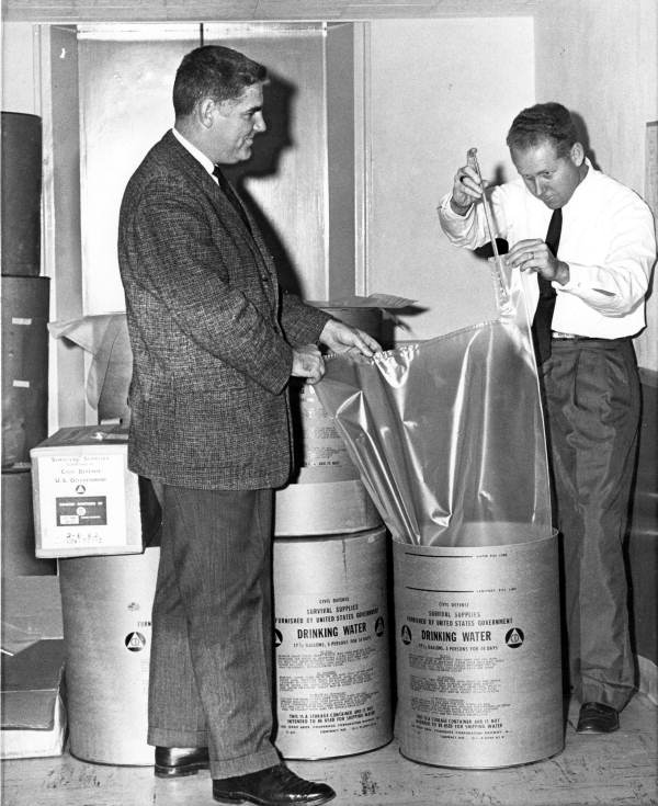 Chlorine is added to water supplies at the fallout shelter in the basement of the old capitol building in Tallahassee. At left is Hal Miller, field operations officer of U.S. Civil Defense Region #3, based in Thomasville, Georgia. At right is Tallahassee city engineer Thomas P. Smith (February 15, 1962).