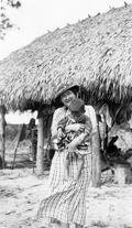 Jule O. Graves with a Seminole Indian child at a temporary camp in Immokalee, Florida.