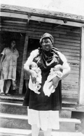 African American midwife holding twins.