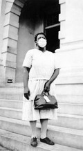 African American midwife wearing a protective mask.