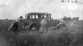 Deaconess Bedell watching the Mikasuki Indians pushing her stuck Model A