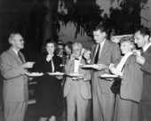 Group of people enjoying food at Governor Caldwell's press conference - Orlando, Florida.