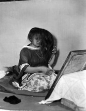 Seminole Indian woman Letagi (who has taken the Christian name of Frances Willie) styling her hair in Miami, Florida.