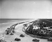 Cars racing on Daytona Beach.