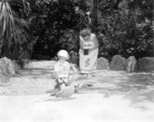 Child feeding parrots at Parrot Jungle - Miami, Florida.