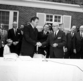 Roy Disney shaking hands with Governor Claude Kirk during the signing of the Disney bill at the Governor's mansion - Tallahassee, Florida.