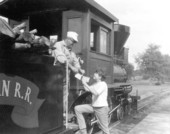 Young visitor gets autograph from train engineer at Pioneer City - Davie, Florida.