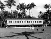 A young girl stands by the passenger car "Rambler" displayed at the Flagler Museum - Palm Beach, Florida.