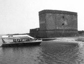 A tour boat anchors beside Fort Matanzas at the waterfront of Matanzas River