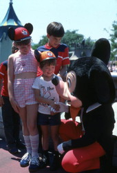 Children meeting Mickey Mouse at the Magic Kingdom amusement park in Orlando, Florida.