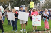 Gun-control activists with their signs at the Old Capitol during the Never Again Rally in Tallahassee.