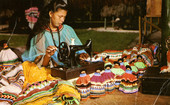 A member of the Seminole Tribe of Florida sewing colorful Indian dress.