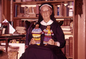 Deaconess Bedell at Glade Cross Mission in Everglades City with Seminole dolls.