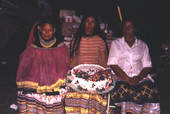 Seminole women with cake during the Christmas feast at Susie Billie's village in Ft. Myers.