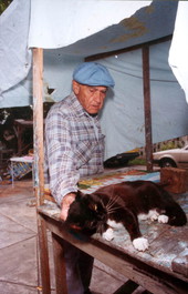 Mario Sanchez taking a break from his art work to pet his cat - Key West, Florida.