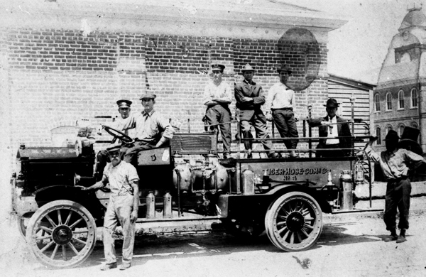 Key West Fire Department personnel and American LaFrance fire truck behind the court house - Key West, Florida.