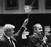 Senator Dick Langley argues against legislation while Senator George Kirkpatrick waves a flag - Tallahassee, Florida.