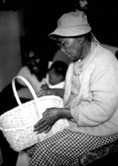 Basket maker Lucreaty Clark holding a white oak basket she made- Lamont, Florida