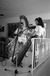 Ana Maria DeArmas playing the Venezuelan harp as Jesus Rodriguez accompanies on cuatro- Naples, Florida